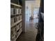 Bright, welcoming hallway leads to a living area with modern shelving and stylish flooring at 5335 Rod Ct # 102, Las Vegas, NV 89122