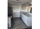 Well-lit kitchen boasts sleek gray cabinets, stainless steel appliances, and granite countertops at 5335 Rod Ct # 102, Las Vegas, NV 89122