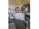 Living room with fireplace, television, industrial shelving, and decorative elements enhancing the interior design at 5335 Rod Ct # 102, Las Vegas, NV 89122