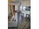 The living room showcases wood laminate flooring, seating, and a small pass-through to the kitchen at 5335 Rod Ct # 102, Las Vegas, NV 89122