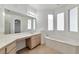 Bright bathroom featuring a large mirror, double sinks and a soaking tub at 5341 Cool Dawn Ct, Las Vegas, NV 89130