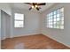 Bedroom with laminate floors, a ceiling fan and windows providing natural light at 5341 Cool Dawn Ct, Las Vegas, NV 89130
