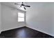 Bedroom with dark wood floors, a ceiling fan and a window offering natural light at 5341 Cool Dawn Ct, Las Vegas, NV 89130