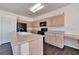 Kitchen with black appliances, island sink, and hardwood floors at 5341 Cool Dawn Ct, Las Vegas, NV 89130