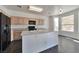 Well-lit kitchen with dark appliances and an island sink at 5341 Cool Dawn Ct, Las Vegas, NV 89130