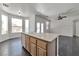 Bright kitchen island featuring a sink with backyard and living room views at 5341 Cool Dawn Ct, Las Vegas, NV 89130