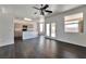 Open-concept living area featuring wood floors, a ceiling fan, and backyard access at 5341 Cool Dawn Ct, Las Vegas, NV 89130