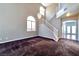 Inviting foyer area with a staircase, chandelier, and carpeted floors at 5341 Cool Dawn Ct, Las Vegas, NV 89130
