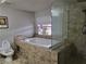 A primary bathroom features a soaking tub and step-in shower with beige tile surround at 603 Palmhurst Dr, Las Vegas, NV 89145