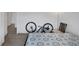 This bedroom features neutral walls, wood-look floors, and a bicycle for the athletic home owner at 603 Palmhurst Dr, Las Vegas, NV 89145