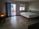 This bedroom features wood-look floors, an adjacent patio, and minimalist modern decor at 603 Palmhurst Dr, Las Vegas, NV 89145