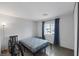 Neutral bedroom with a simple bed frame, window, and a bicycle at 603 Palmhurst Dr, Las Vegas, NV 89145