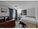 Cozy bedroom features wood-look floors, a window view, and interesting decorative touches at 603 Palmhurst Dr, Las Vegas, NV 89145