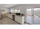 Bright kitchen area with granite countertops, stainless steel appliances, and access to outdoor patio at 603 Palmhurst Dr, Las Vegas, NV 89145