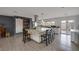 Spacious kitchen with a large island, stainless steel appliances, granite counters, and sliding door access to the yard at 603 Palmhurst Dr, Las Vegas, NV 89145