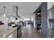 Open concept kitchen with island, stainless appliances, and easy flow to the living and dining spaces at 603 Palmhurst Dr, Las Vegas, NV 89145