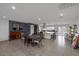Open dining and kitchen with island seating, dark wood table, and accent wall at 603 Palmhurst Dr, Las Vegas, NV 89145