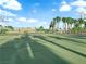 Community basketball court with palm tree lined fence and playground in background at 6231 Curlew Dr, Las Vegas, NV 89122