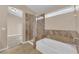 Bathroom featuring a standalone tub, glass shower, and neutral walls at 6231 Curlew Dr, Las Vegas, NV 89122
