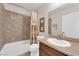 Bathroom featuring tub/shower combo with tiled walls, single vanity, and toilet at 6231 Curlew Dr, Las Vegas, NV 89122