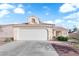 Single story home featuring desert landscaping, a two car garage, and a light colored exterior at 6231 Curlew Dr, Las Vegas, NV 89122