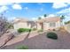 Single story home featuring desert landscaping, a two car garage, and a light colored exterior at 6231 Curlew Dr, Las Vegas, NV 89122