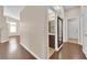 Bright hallway featuring modern wood floors and access to a half bathroom with vanity and updated fixtures at 6231 Curlew Dr, Las Vegas, NV 89122