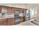 Modern kitchen featuring stainless steel appliances, dark wood cabinets, and a mosaic backsplash at 6231 Curlew Dr, Las Vegas, NV 89122