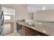 Kitchen sink area with granite countertops, and a partial view of an open-concept living area at 6231 Curlew Dr, Las Vegas, NV 89122