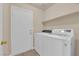 Laundry room featuring a white washer and dryer along with shelving at 6231 Curlew Dr, Las Vegas, NV 89122