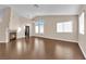 Bright living room with wood floors, a fireplace, and multiple windows for natural light at 6231 Curlew Dr, Las Vegas, NV 89122