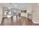 Bright, open-concept living room featuring a fireplace, hardwood floors and abundant natural light at 6231 Curlew Dr, Las Vegas, NV 89122