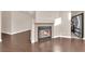 Living room featuring a fireplace, wood floors, and a partial view of the kitchen area at 6231 Curlew Dr, Las Vegas, NV 89122