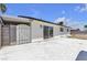 A white home has a large backyard concrete patio and a sliding glass door for indoor/outdoor living at 6305 Fairwood Ave, Las Vegas, NV 89107