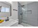 Modern bathroom featuring a glass-enclosed shower with blue vertical tiles, and sleek black fixtures at 6305 Fairwood Ave, Las Vegas, NV 89107