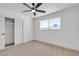 Well lit bedroom featuring carpet, a ceiling fan, and a large closet with sliding doors at 6305 Fairwood Ave, Las Vegas, NV 89107
