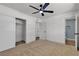 Bright bedroom featuring neutral carpet, ceiling fan, and closet with sliding doors at 6305 Fairwood Ave, Las Vegas, NV 89107