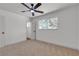 Bedroom featuring neutral carpet, a modern ceiling fan, and bright natural light from the large window at 6305 Fairwood Ave, Las Vegas, NV 89107