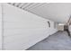 Exterior wall and walkway under the carport featuring clean white siding and concrete pathway at 6305 Fairwood Ave, Las Vegas, NV 89107