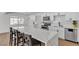 Modern kitchen featuring white cabinets, stainless steel appliances, and a large island with bar seating at 6305 Fairwood Ave, Las Vegas, NV 89107