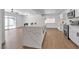 Modern kitchen featuring white cabinets, stainless steel appliances, and a large island with bar seating at 6305 Fairwood Ave, Las Vegas, NV 89107