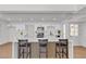 Modern kitchen featuring white cabinets, stainless steel appliances, and a large island with bar seating at 6305 Fairwood Ave, Las Vegas, NV 89107