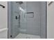 Stylish walk-in shower with gray vertical tiling, glass enclosure, and sleek black hardware at 6305 Fairwood Ave, Las Vegas, NV 89107