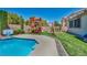 Resort-style backyard featuring a pool, built-in basketball hoop, and play structure at 6423 Grayback Dr, North Las Vegas, NV 89084