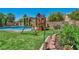 Spacious backyard features a pool, play structure, garden and artificial turf for easy upkeep at 6423 Grayback Dr, North Las Vegas, NV 89084