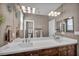 Bright bathroom featuring a dual sink vanity with a white countertop and stylish light fixtures at 6423 Grayback Dr, North Las Vegas, NV 89084
