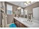 Bathroom featuring double vanity, a large mirror, and decorative wall accents at 6423 Grayback Dr, North Las Vegas, NV 89084