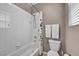 Bathroom with a shower and bathtub combo and white tile at 6423 Grayback Dr, North Las Vegas, NV 89084