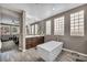 Bright bathroom with a freestanding tub, glass block windows, and wood-look tile flooring at 6423 Grayback Dr, North Las Vegas, NV 89084