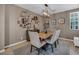 Charming dining room with a rustic table, unique decor, and natural light, ideal for intimate gatherings and meals at 6423 Grayback Dr, North Las Vegas, NV 89084